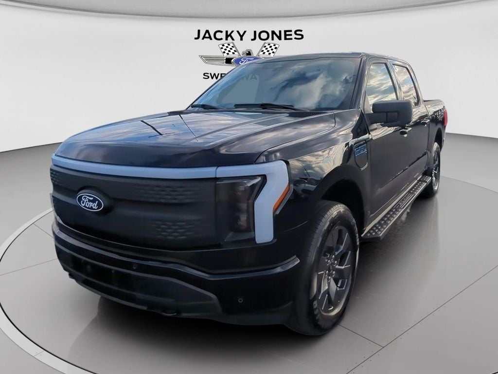 2025 Ford F-150 Lightning Flash Available Demo in Agate Black Metallic — front three-quarter view