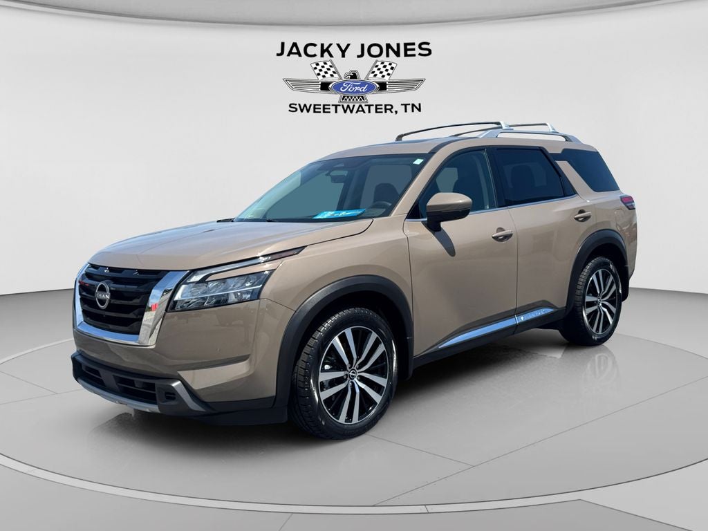 2024 Nissan Pathfinder Platinum in Baja Storm — front three-quarter view